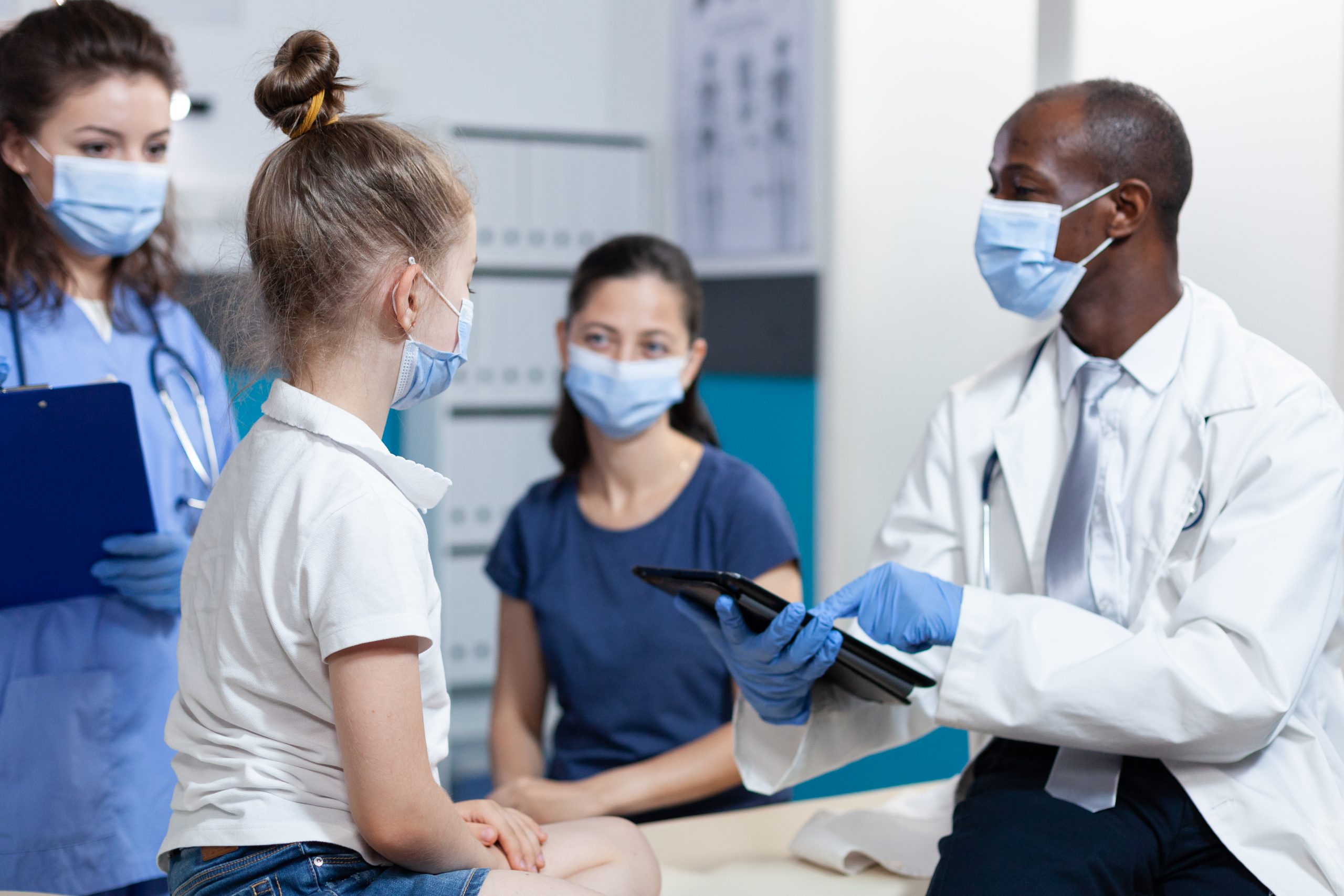 African american pediatrician doctor with protection face mask against coronavirus